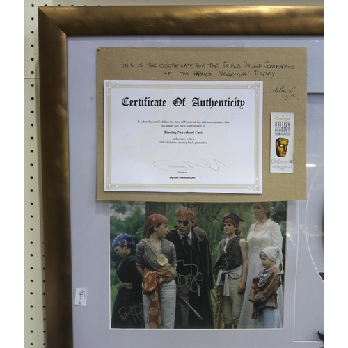 555 - A framed display commemorating the 2004 film Finding Neverland, featuring a photograph signed by cas... 