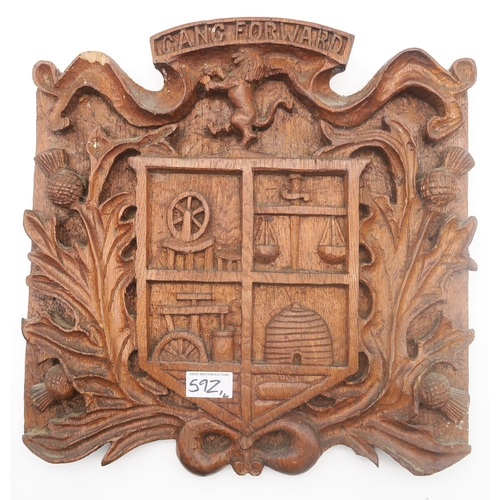 592 - A hand-carved McNally family heraldic shield plaque, dated 1998 verso and measuring approx. 54cm in ... 