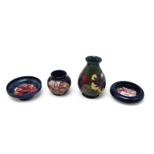 207 - A collection of Moorcroft pottery including two Anemone pattern dishes, a Hibiscus pattern vase and ... 