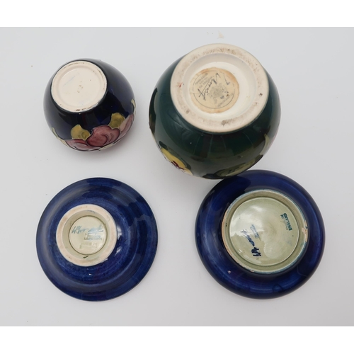 207 - A collection of Moorcroft pottery including two Anemone pattern dishes, a Hibiscus pattern vase and ... 