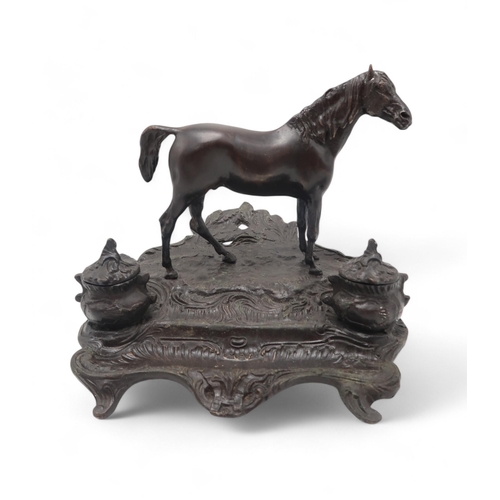 222 - A cast metal desk stand modelled as a horse on naturalistic base, with two inkwells