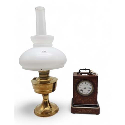 246 - A French inlaid wooden clock, the dial marked Andre a Paris, together with a brass oil lamp