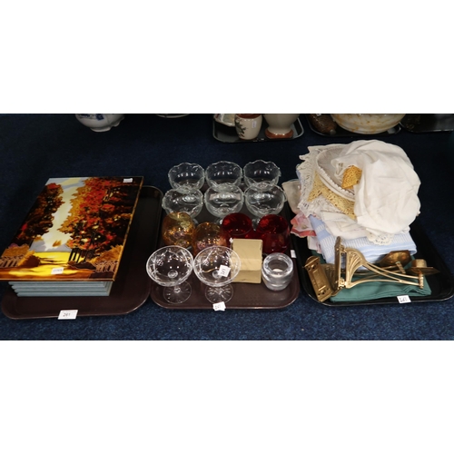 261 - Assorted glassware, table linen, a pair of wall mounted candlesticks etc