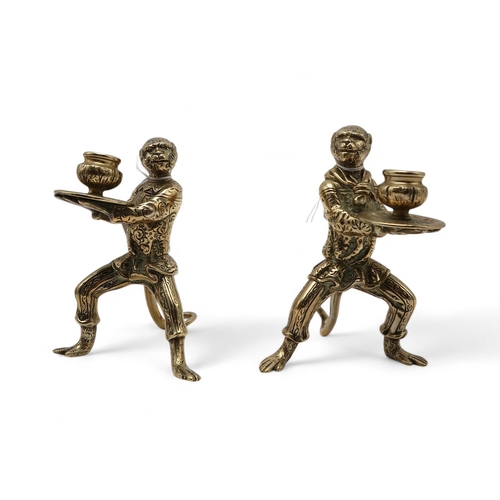 276 - A pair of bronze waiter monkey candlesticks