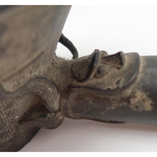 327 - A Chinese bronze silk iron, cast with archaistic decoration, with wooden handle, 36cm long