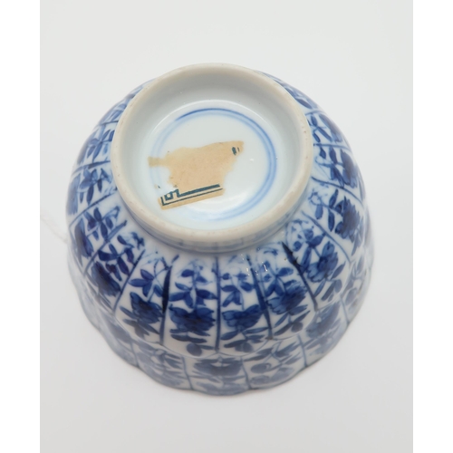 332 - A Chinese blue and white tea bowl, decorated with bands of lappits filled with flowers, 8cm diameter... 