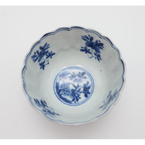 332 - A Chinese blue and white tea bowl, decorated with bands of lappits filled with flowers, 8cm diameter... 