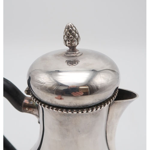 2520 - A DUTCH SILVER COFFEE POTof baluster form, with a beaded rim and pineapple finial, with a carved ebo... 