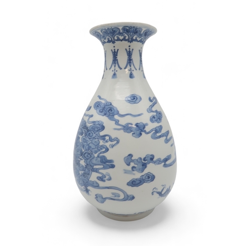 2402 - AN ASIAN BLUE AND WHITE BALUSTER VASE Painted with a dragon, fish, clouds and waves, blue six charac... 