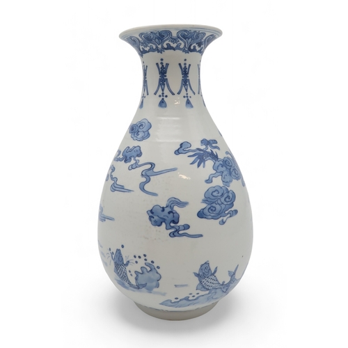 2402 - AN ASIAN BLUE AND WHITE BALUSTER VASE Painted with a dragon, fish, clouds and waves, blue six charac... 