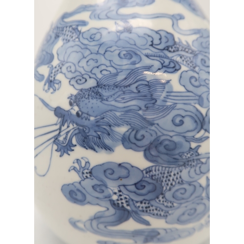 2402 - AN ASIAN BLUE AND WHITE BALUSTER VASE Painted with a dragon, fish, clouds and waves, blue six charac... 