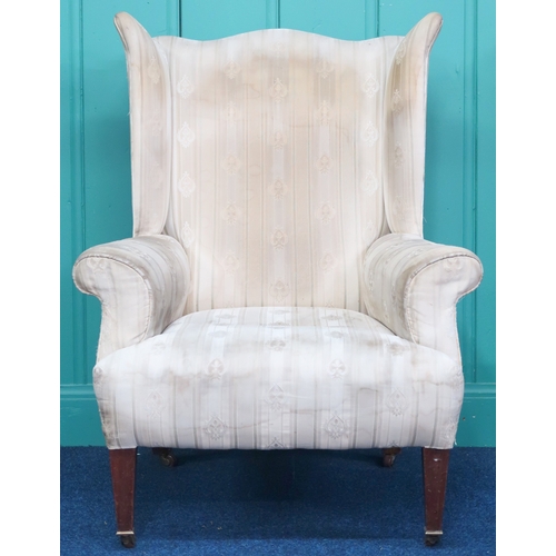 2009 - AN EDWARDIAN WINGBACK ARMCHAIR with shaped wingback over scrolled arms on square tapering supports t... 