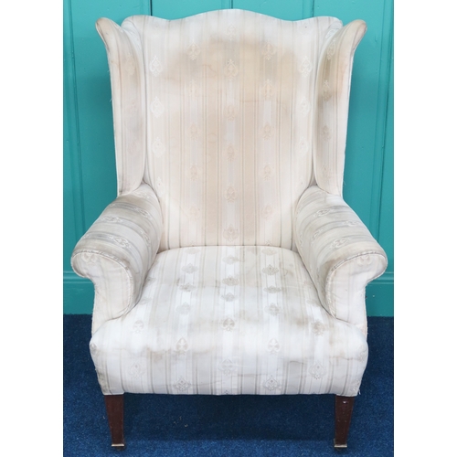 2009 - AN EDWARDIAN WINGBACK ARMCHAIR with shaped wingback over scrolled arms on square tapering supports t... 