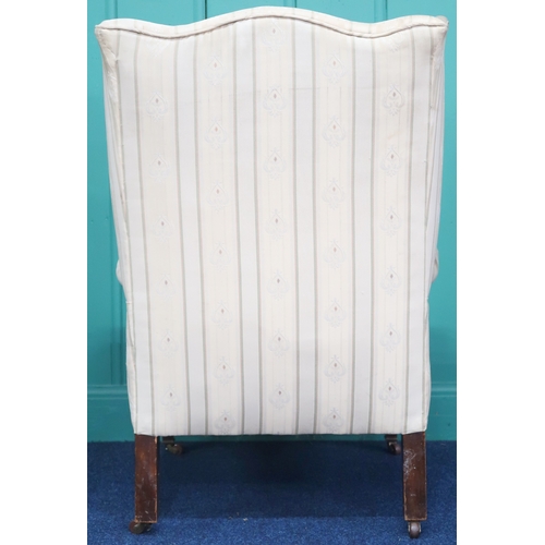 2009 - AN EDWARDIAN WINGBACK ARMCHAIR with shaped wingback over scrolled arms on square tapering supports t... 