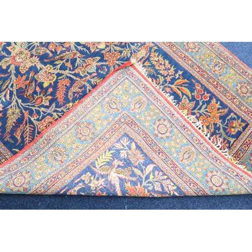 2150 - A DARK BLUE GROUND TREE OF LIFE PATTERNED RUG with multicoloured stylistic animals and birds amongst... 