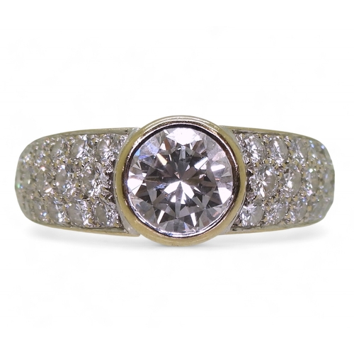 2700 - A CARTIER DIAMOND RINGthe central 1ct diamond is rub over set with pave set diamond shoulders with a... 