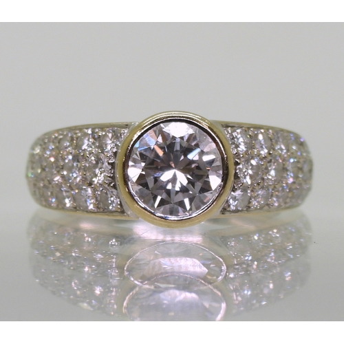 2700 - A CARTIER DIAMOND RINGthe central 1ct diamond is rub over set with pave set diamond shoulders with a... 