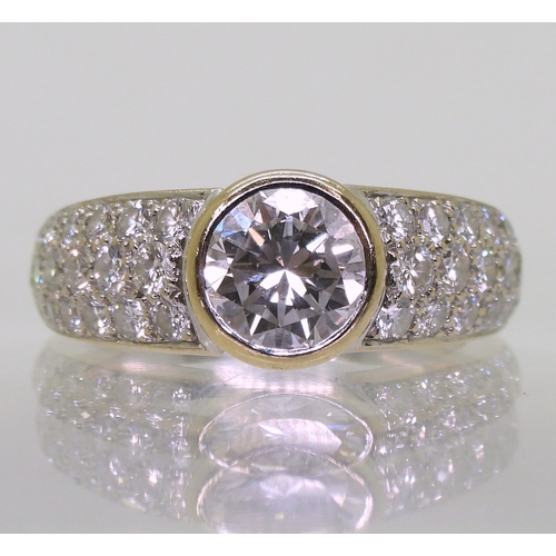 2700 - A CARTIER DIAMOND RINGthe central 1ct diamond is rub over set with pave set diamond shoulders with a... 