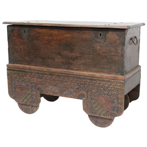 2011 - A 20TH CENTURY INDONESIAN HARDWOOD WHEELED RICE/DOWRY CHESTwith hinged top concealing two candle dep... 