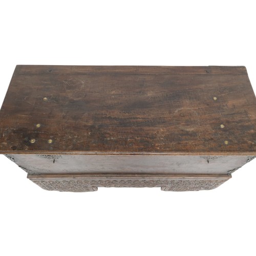 2011 - A 20TH CENTURY INDONESIAN HARDWOOD WHEELED RICE/DOWRY CHESTwith hinged top concealing two candle dep... 