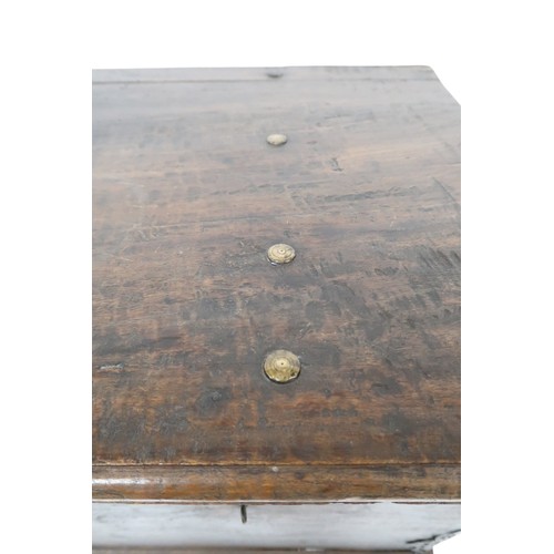 2011 - A 20TH CENTURY INDONESIAN HARDWOOD WHEELED RICE/DOWRY CHESTwith hinged top concealing two candle dep... 