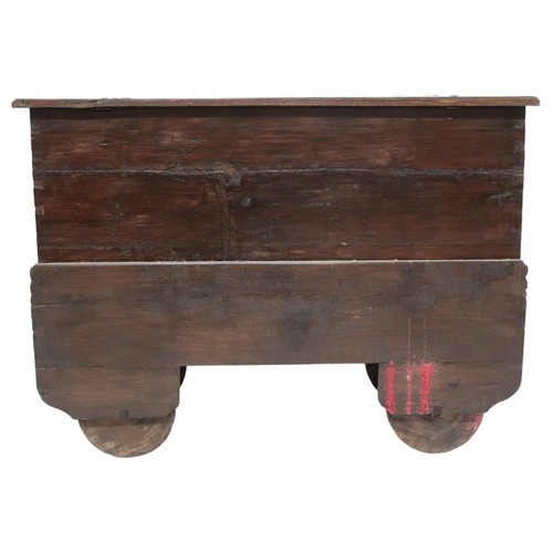 2011 - A 20TH CENTURY INDONESIAN HARDWOOD WHEELED RICE/DOWRY CHESTwith hinged top concealing two candle dep... 