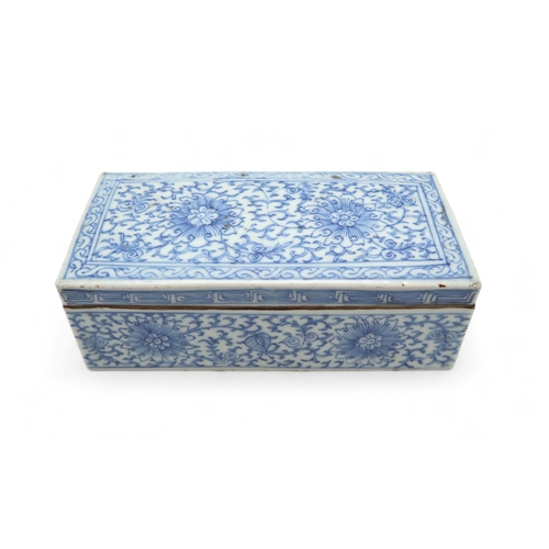 2408 - A CHINESE BLUE AND WHITE PEN BOX Painted with stylised flowers and scrolling foliage, 18cm wide, 8.5... 