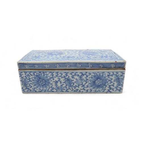 2408 - A CHINESE BLUE AND WHITE PEN BOX Painted with stylised flowers and scrolling foliage, 18cm wide, 8.5... 