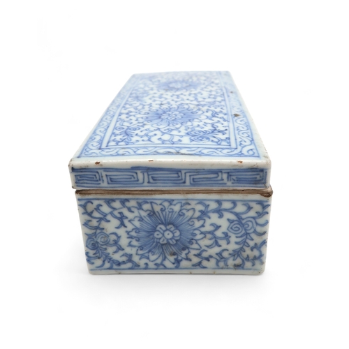 2408 - A CHINESE BLUE AND WHITE PEN BOX Painted with stylised flowers and scrolling foliage, 18cm wide, 8.5... 