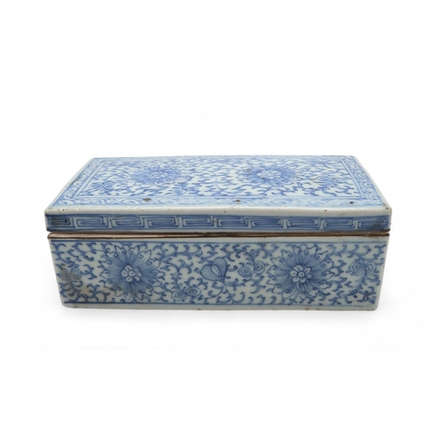 2408 - A CHINESE BLUE AND WHITE PEN BOX Painted with stylised flowers and scrolling foliage, 18cm wide, 8.5... 