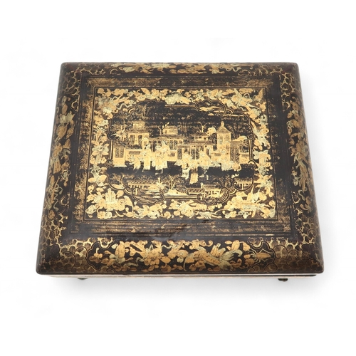 2410 - A CHINESE EXPORT BLACK AND GOLD LAQUERED GAMES BOXDecorated with figures before buildings and within... 