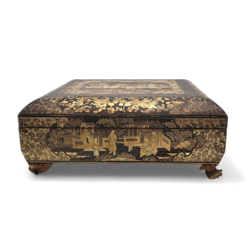 2410 - A CHINESE EXPORT BLACK AND GOLD LAQUERED GAMES BOXDecorated with figures before buildings and within... 