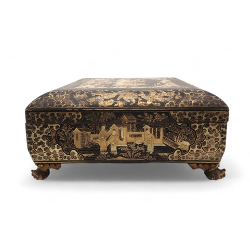 2410 - A CHINESE EXPORT BLACK AND GOLD LAQUERED GAMES BOXDecorated with figures before buildings and within... 