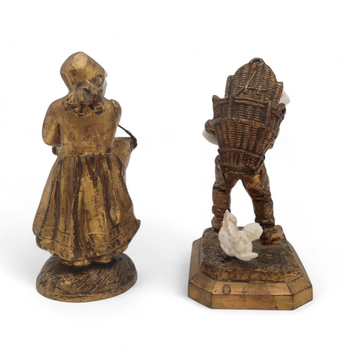 2203 - TWO FRENCH MEDNAT SCULPTURESin gilded metal and bisque porcelain, modelled as a girl carrying a larg... 