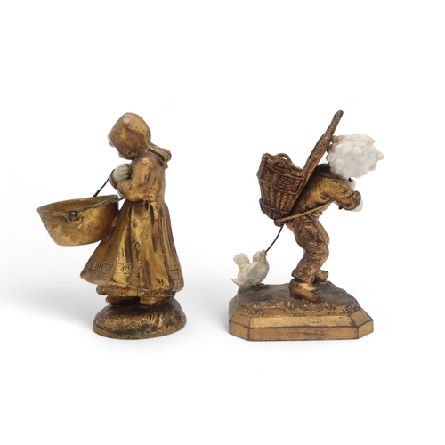 2203 - TWO FRENCH MEDNAT SCULPTURESin gilded metal and bisque porcelain, modelled as a girl carrying a larg... 