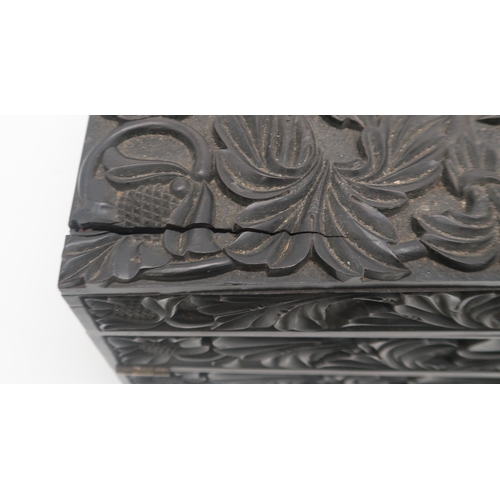 2213 - A 19TH CENTURY CARVED EBONY WRITING BOXcarved all over with scrolling foliage and pomegranates, 42cm... 