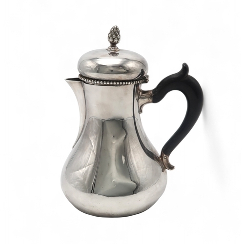 2520 - A DUTCH SILVER COFFEE POTof baluster form, with a beaded rim and pineapple finial, with a carved ebo... 