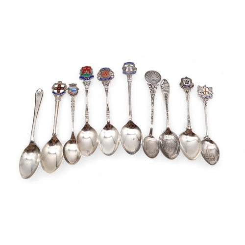 411 - A collection of enamel silver and stamped 800 souvenir spoons, a Mexican example, an American spoon ... 