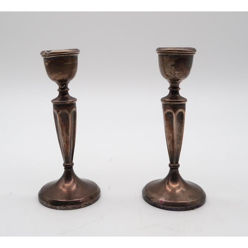 417 - A pair of silver candlestick (weighted), Aaron Lufkin Dennison, Birmingham 1907, of tapering fa... 