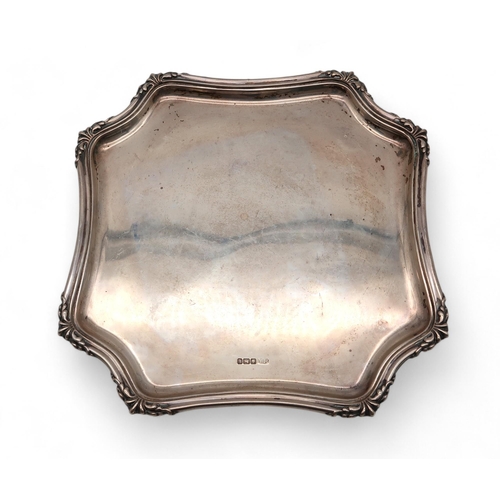 425 - A silver salver, by Atkins Brothers, Sheffield, of shaped square form, on domed feet, 24cm, 561gms