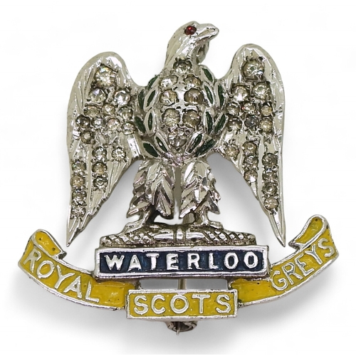 703 - A Royal Scots Greys sweetheart brooch, made in silver the eagle set with clear gems, with painted de... 