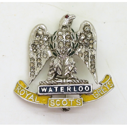 703 - A Royal Scots Greys sweetheart brooch, made in silver the eagle set with clear gems, with painted de... 