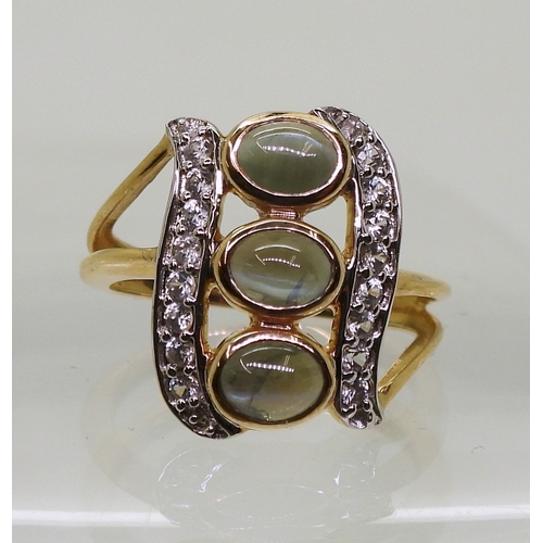 745 - An alexandrite and zircon ring, mounted in 9ct gold, the three cats eye alexandrites are approx... 