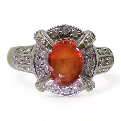 806 - A 14ct white gold, orange gem and diamond accent ring, size N1/2, weight 4.0gms