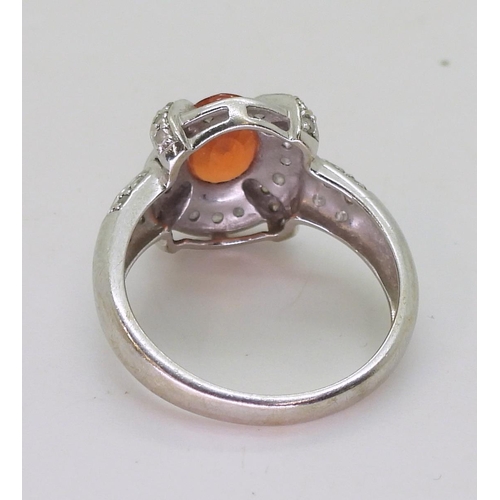 806 - A 14ct white gold, orange gem and diamond accent ring, size N1/2, weight 4.0gms