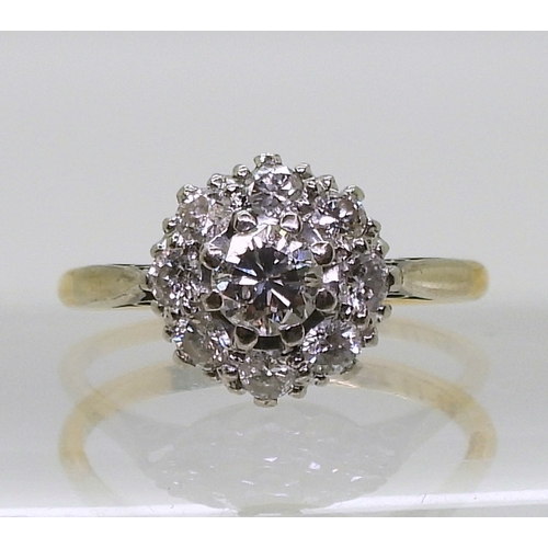 814 - A diamond cluster ring, the 18ct yellow gold and platinum mount is set with estimated approx 0.50cts... 