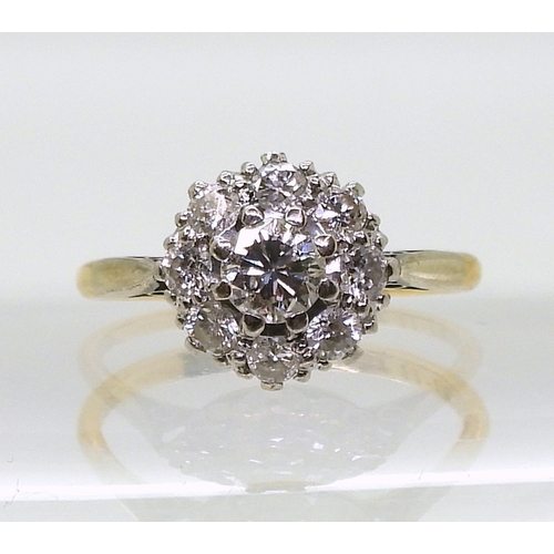 814 - A diamond cluster ring, the 18ct yellow gold and platinum mount is set with estimated approx 0.50cts... 