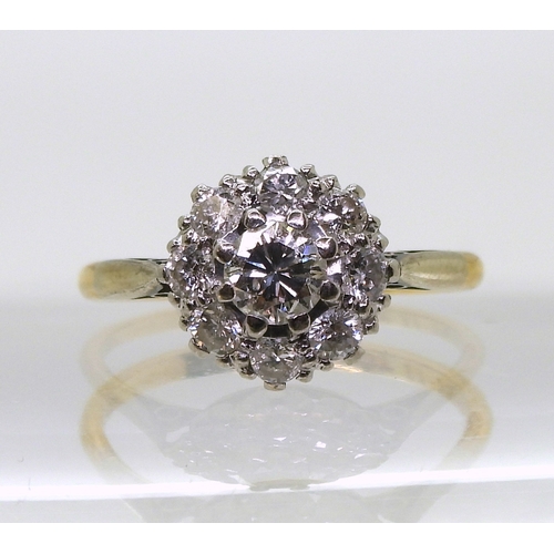 814 - A diamond cluster ring, the 18ct yellow gold and platinum mount is set with estimated approx 0.50cts... 