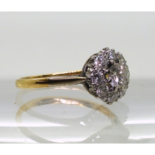 814 - A diamond cluster ring, the 18ct yellow gold and platinum mount is set with estimated approx 0.50cts... 