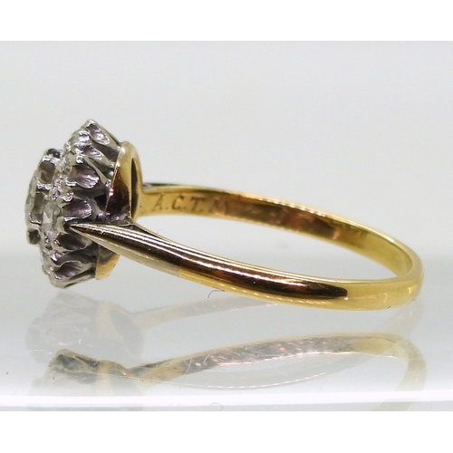 814 - A diamond cluster ring, the 18ct yellow gold and platinum mount is set with estimated approx 0.50cts... 